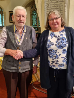 Bob Hills (left) receiving the award with Janet Lister (right) presenting